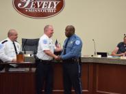 Three officers with two of them shaking hands